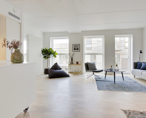 The living room is both bright and beautiful with the wooden floors and big windows.